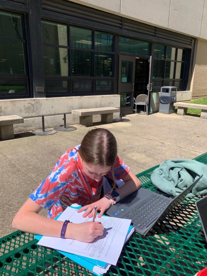 In the Library Media Center courtyard, sophomore Taylor Arth prepares for her ELA 2 end-of-course exam. 