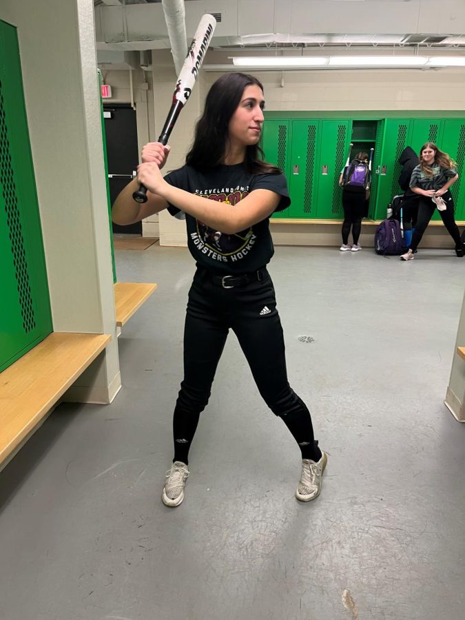 Sophomore Francesca Diasio practices her batting stance in the locker room.