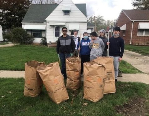 Members of Interact Club finish cleaning-up a neighborhood yard during one of their events in 2021.